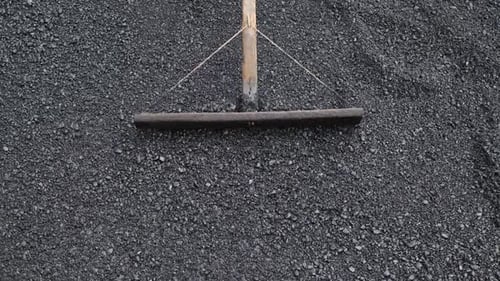 The Road Construction Crew Used Shovels and Mops to Level the Asphalt for a New Coating