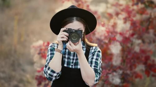 Woman Photographing in Autumn Landscape