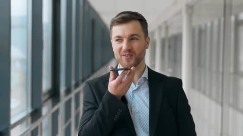 Man in Suit Talking on Phone in Office