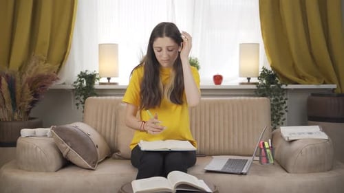 Student Studies at Home With Laptop and Notes