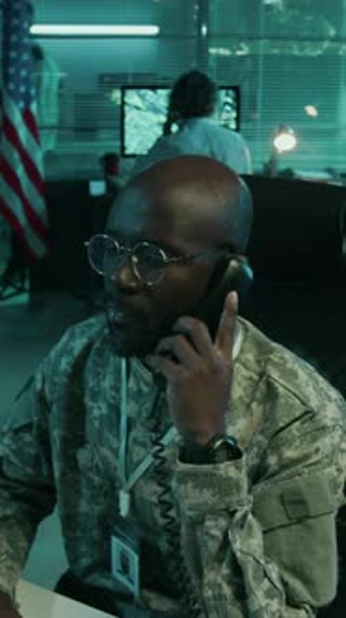 Male Military Officer in Camouflage Working on Computer in Command Center