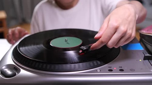 Placing Needle on Spinning Vinyl Record on Turntable