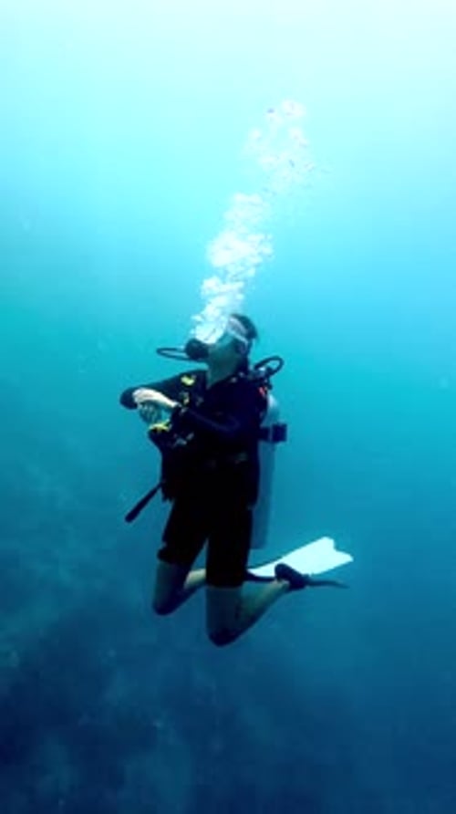 Scuba Diver Exploring Underwater World with Bubbles