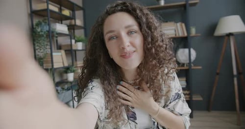 Enthusiastic Woman Recording Video in Home Interior