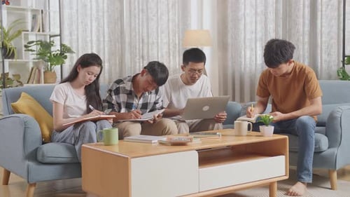 Four Young Adults Studying Together Indoors