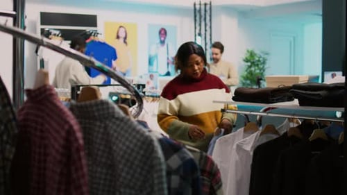 Store Customer Taking Shirt Off of Hangers to Buy Clothes