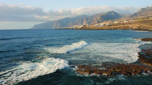 Aerial Shot of Empty Rocky Volcanic Beach at the Atlantic Ocean in the Soft Morning Light Flying Low