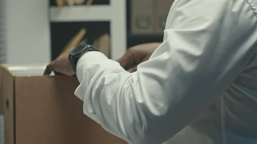 Worker Sorting Paperwork in Office Filing Archives