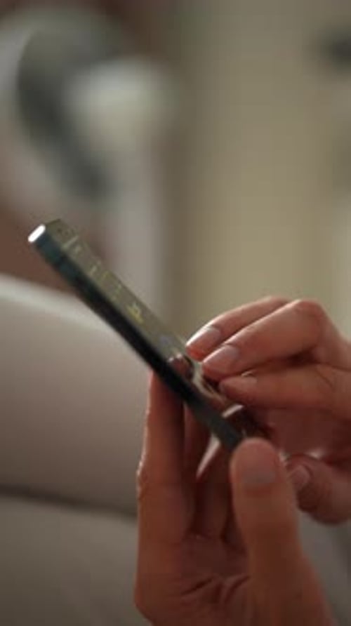 Closeup Vertical Shot of Unrecognizable Man Tapping Fingers on Mobile Phone Screen to Farming New