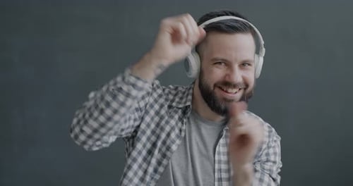 Man with Headphones Dancing and Smiling