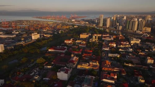 Aerial View of Manila's Skyline at Sunset Featuring Manila Cathedral Bustling Streets and the Port