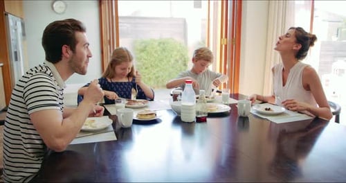 Family Enjoys Breakfast Together in Bright Home