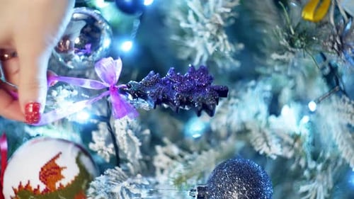 Decorating Christmas Tree with Festive Ornaments at Home
