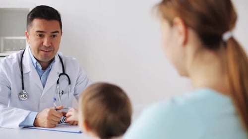 Doctor talking to mother and baby at clinic