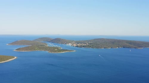 Aerial view of majestic forest islands, blue sea on bright sunny day