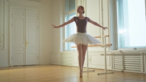 Auburn Haired Ballerina Practicing Dance in Bright Studio