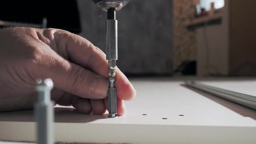 Assembling Furniture with a Power Drill Indoors