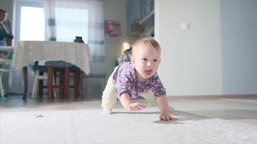 Happy baby plays in the room and learns to walk