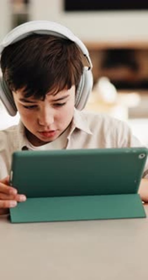 Headphones, tablet and boy for home education, online learning and listening to audio