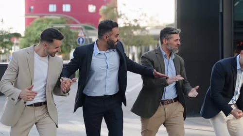 Happy business team walking together celebrating success