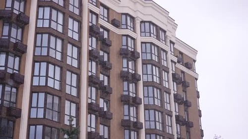 White Snow Falling Outdoors at Background of Multistorey Residential Building