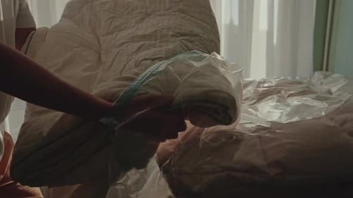 Adult Packing Comforter into Clear Storage Bag