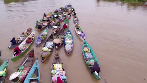 Aerial view of floating market with colorful boats, Indonesia.