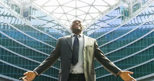 Man Celebrates Success in front of Office Building