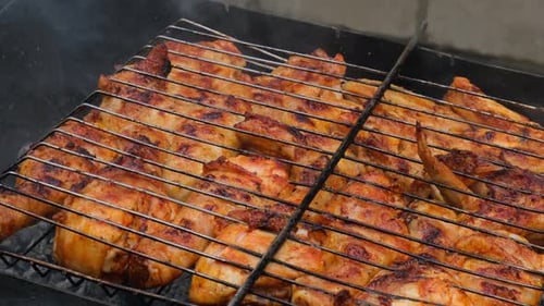 Delicious Chicken Frying on Barbecue Grill Grate Outdoor Seasoning Falling on Fresh Grilled Chicken