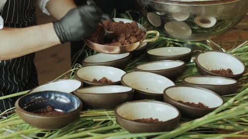 A Person is Pouring Chocolate Into Multiple Bowls on a Table