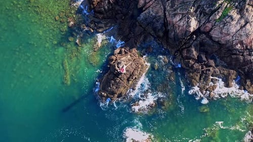 Aerial Top view of a transparent blue sea with beautiful waves at sunny day in summer. air of ocean
