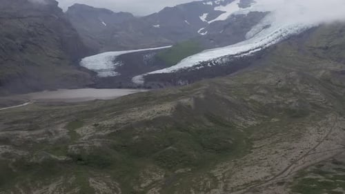 Scenic Iceland natural snowy mountain setting drone aerial misty morning flight