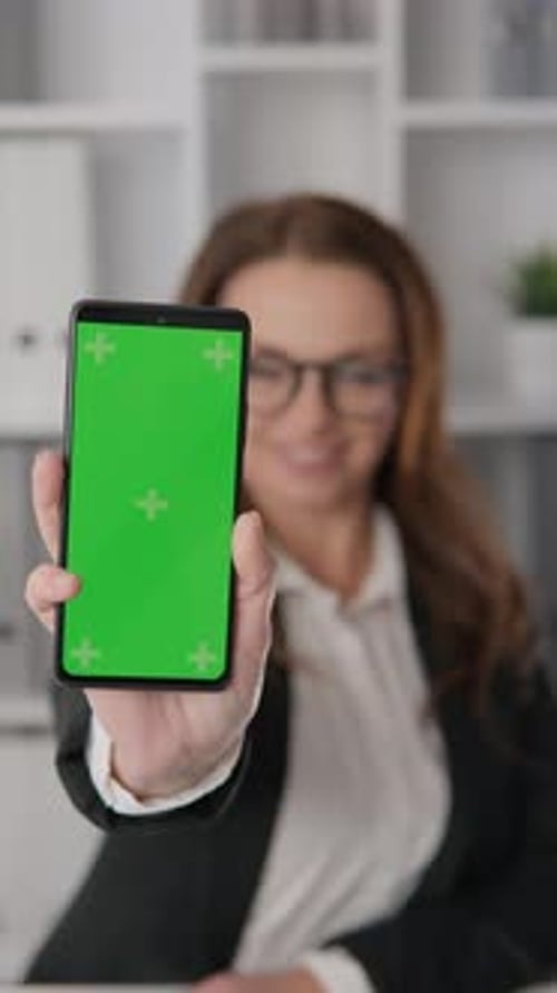 Businesswoman Holding Smartphone Green Screen Chroma Key in Her Hand A Woman Representing Business
