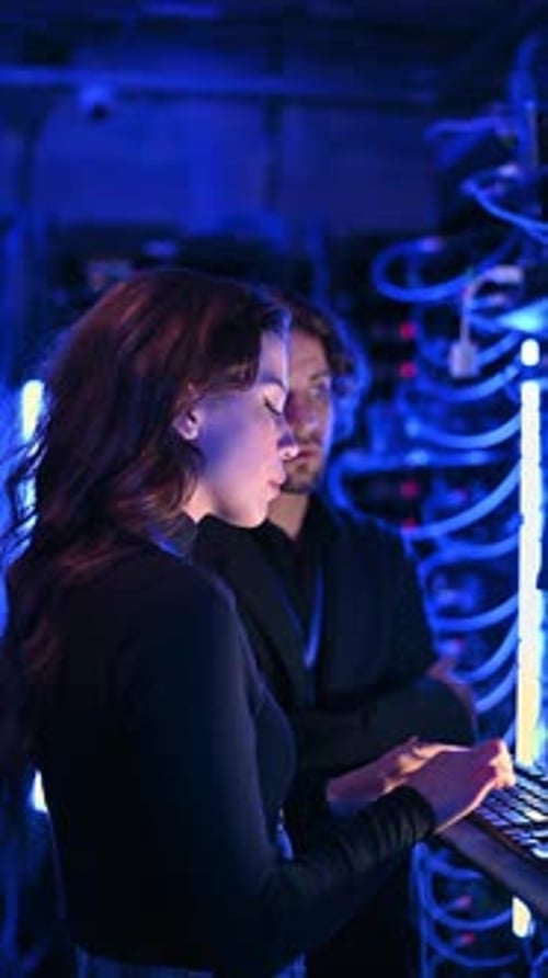 Woman Works with Server in Data Center