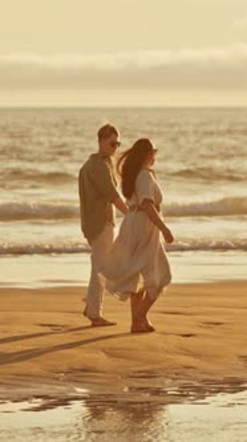 Romantic Couple Walking on Beach at Sunset