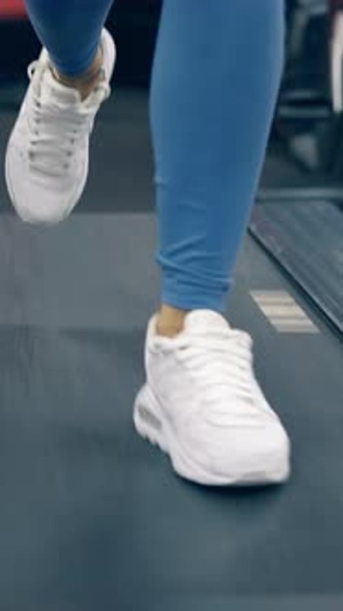 Close View Woman Legs in White Sneakers on Modern Treadmill
