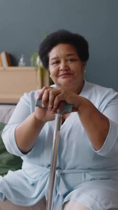 Senior Woman Smiling and Sitting with Cane