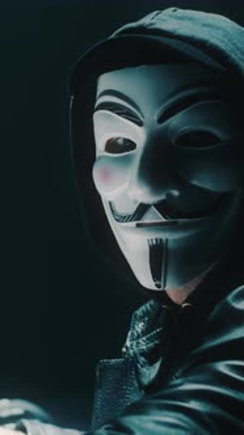 Male Cybercriminal Looking at the Camera