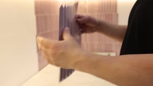 Tile Installation: Applying Pink Hexagon Tiles to Wall