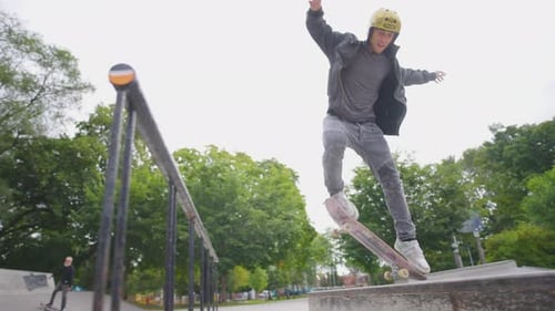 Young Adult Skateboarding Trick in Urban Skate Park