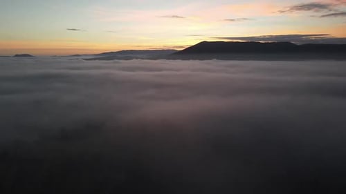 Aerial View of Foggy Landscape at Sunrise