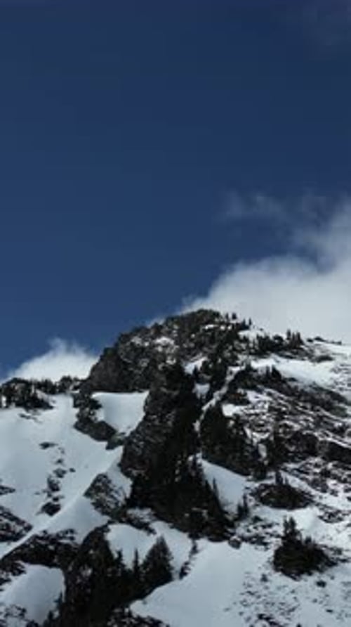 Snowy Mountain Peak, Blue Sky and Clouds. British Columbia, Canada.