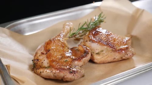 Seasoned Chicken Quarters with Rosemary on Tray