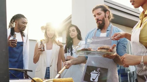 Friends Grilling Meat and Vegetables at a Rooftop Barbecue