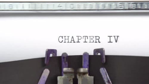 Chapter Four phrase closeup being typing and centered on a sheet of paper on old vintage typewrite