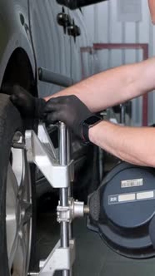 The Master Makes the Camber of the Wheels of the Car Balancing the Chassis of the Car Car Service
