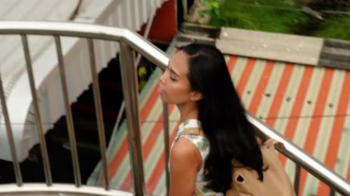 Thai Woman walking on the sidewalk. Bangkok Thailand.