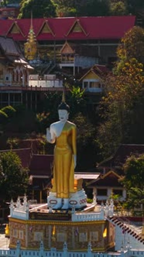 Golden Buddha Statue Resting Serenely Within Ancient Abandoned Temple Nestled Among Northern