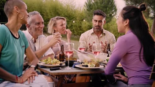Friends Gather for Outdoor Meal and Conversation