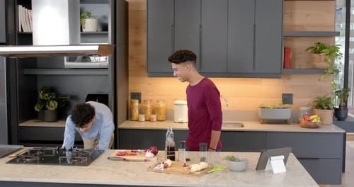 Young Adults Preparing Food Together in Kitchen